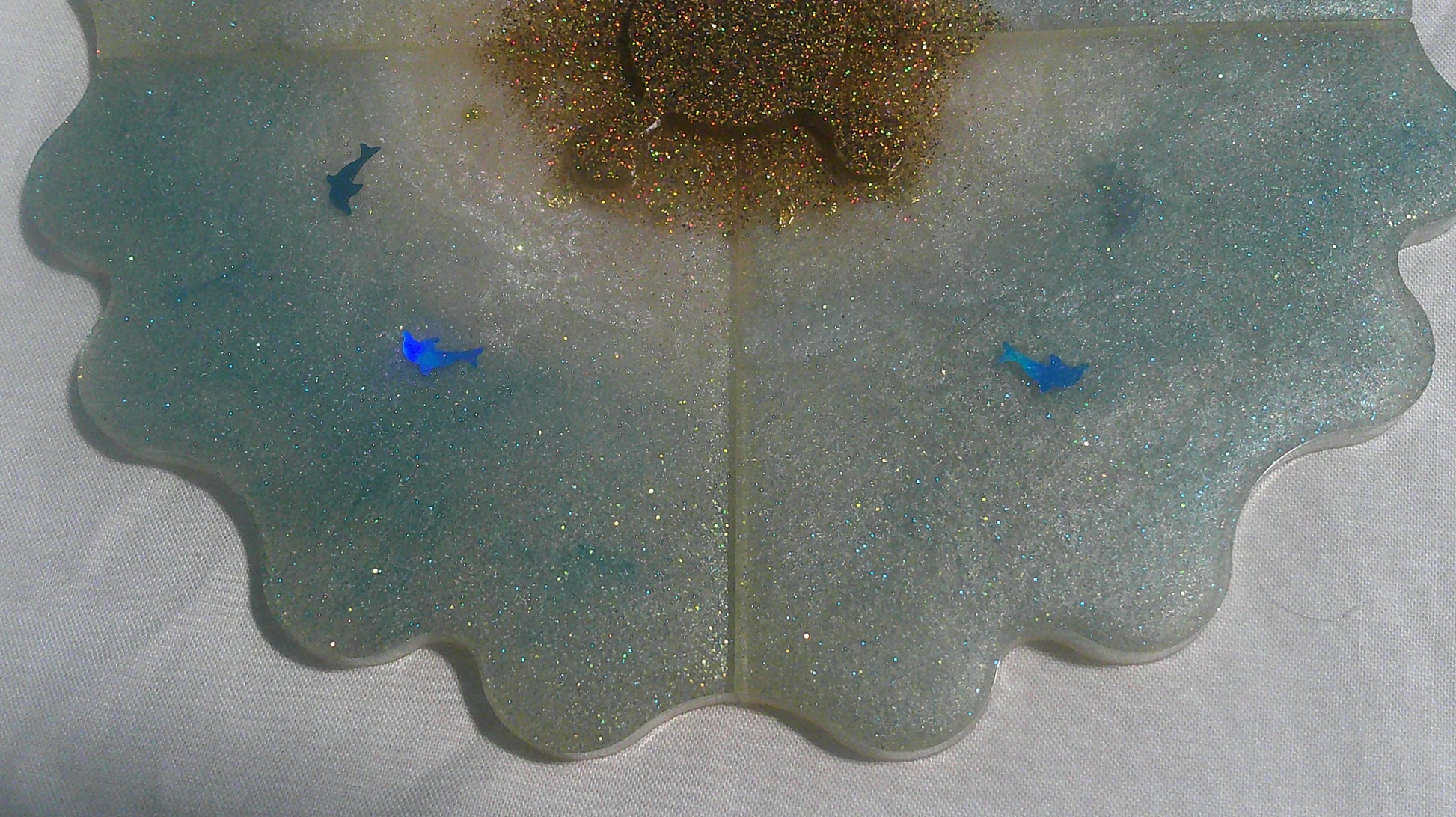 Dolphin puzzle coaster close up - blue dolphins in resin