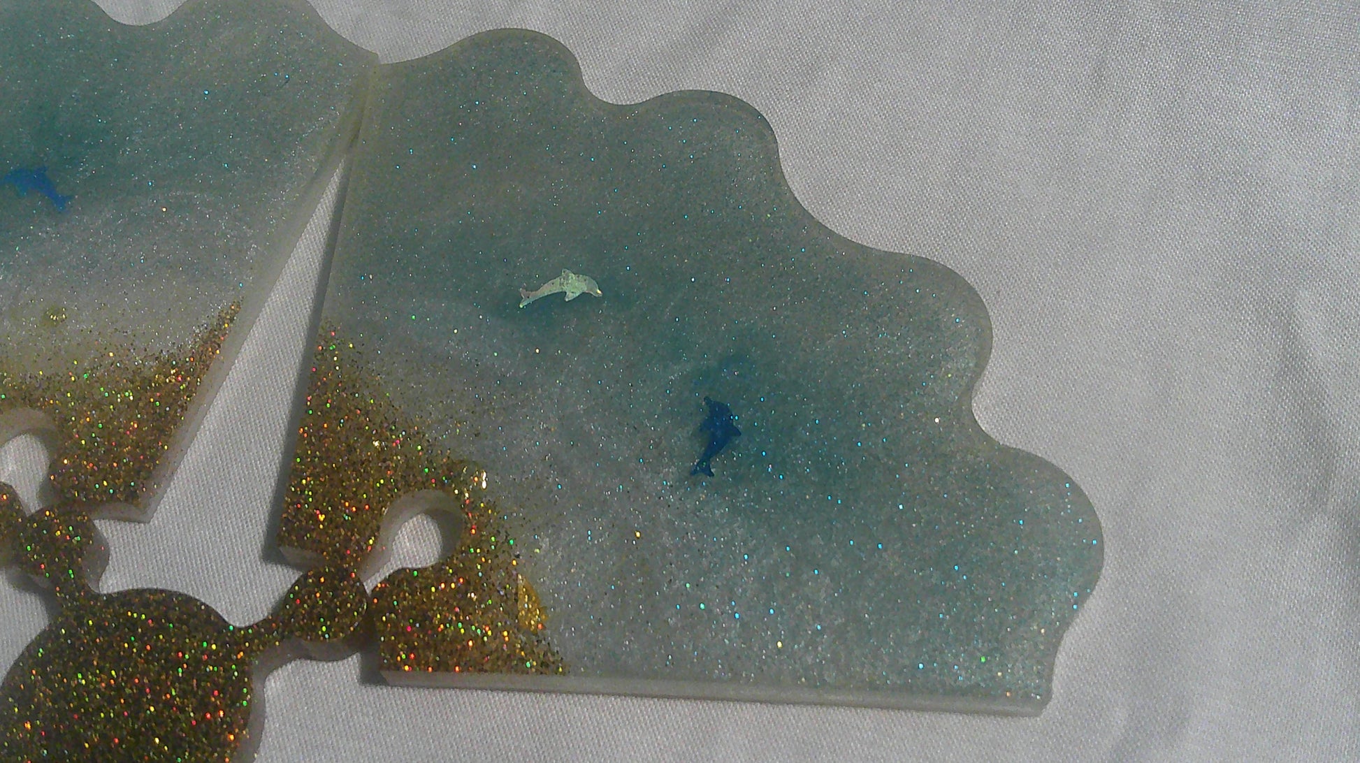 Dolphin puzzle coaster pieces apart - top view