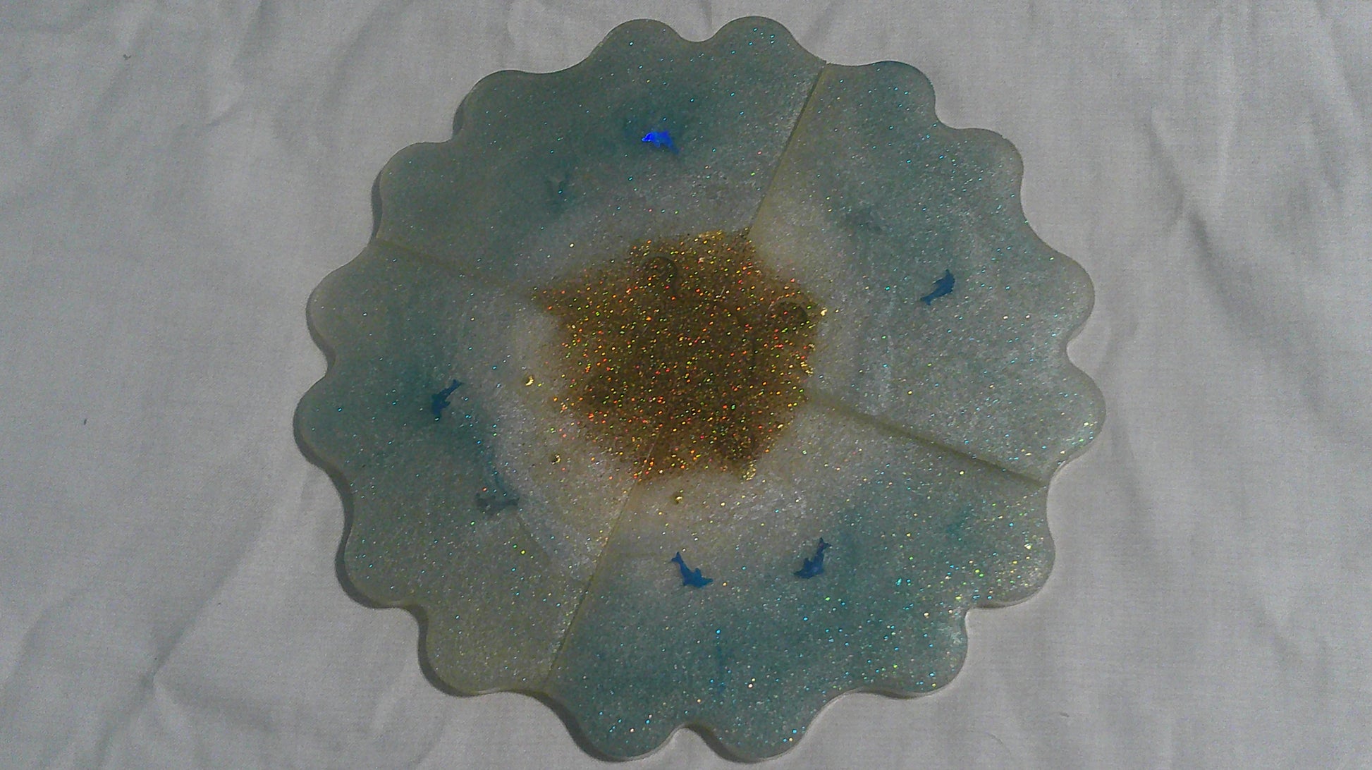 Dolphin puzzle coaster pieces apart - angle view
